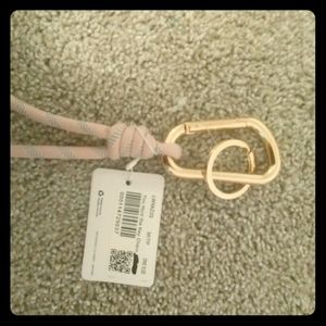 A rose gold/ pink keychain.